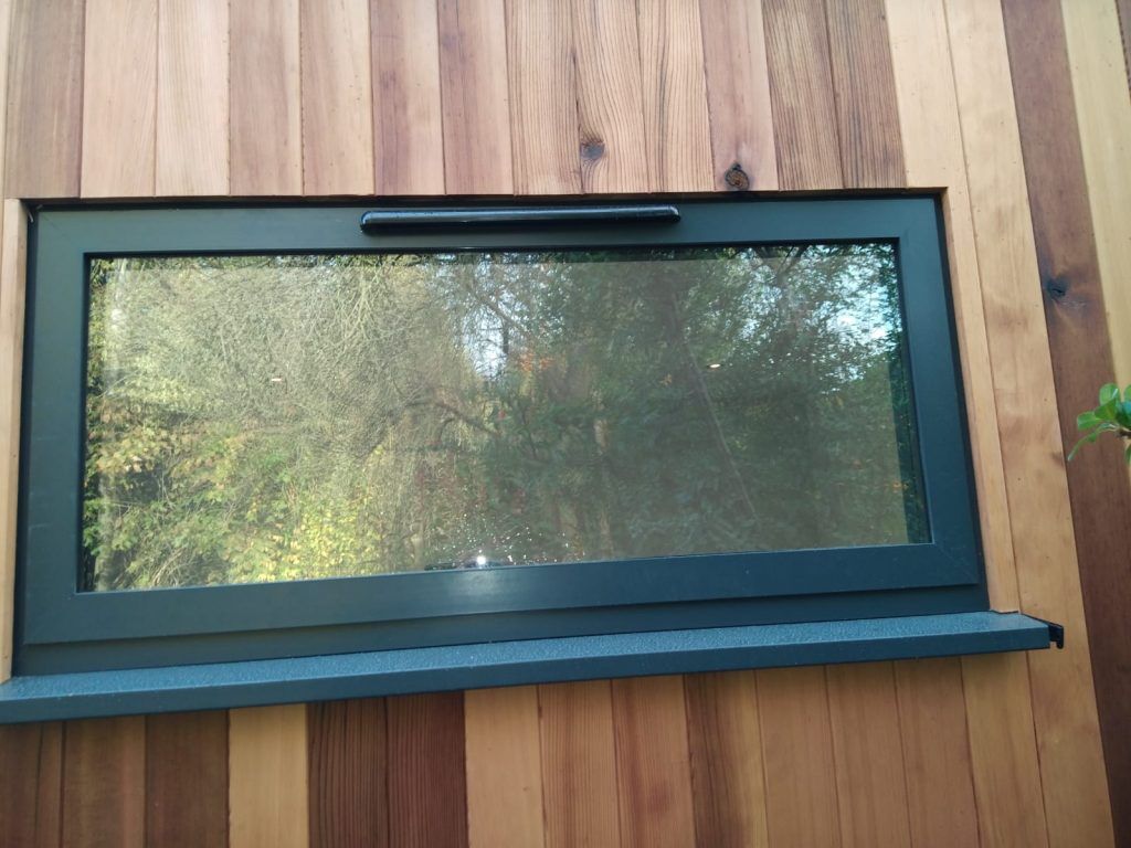 sauna room with bottom hung swing window in black aluminium
