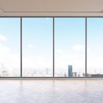 man looks out of Panoramic aluminium windows
