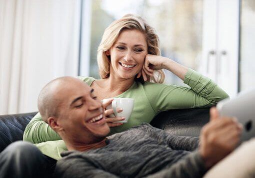 Couple choosing double glazing from catalogue