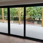 commercial doors , black frame and thick glass at building 344 old street