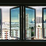 COMMERCIAL CASEMENT WINDOWS FROM THE INSIDE LOOKING OUT OF THREE OPENINGS TO A BUSY HIGH RISE AREA