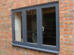 grey upvc windows closed on brick wall