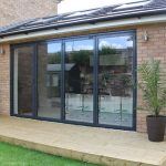Grey 4 panel external aluminium bifold doors on a west london home
