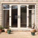 upvc french doors in white with side windows either side that open