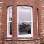 SIMPLE SASH WINDOW UNIT IN A BAY STYLE ON BRICK HOUSE
