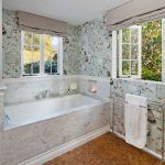 BATHROOM CASEMENT WINDOWS FULLY OPENED FOR DISPL;AY AND A MODERN BATHROOM SETUP IN ALL CREAM