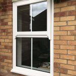 A CLOSED CENTRE BAR SASH WINDOW FRAME WITH TRIPLE GLAZED GLASS FULLY CLOSED AND LOCKED ON RESIDENTIAL HOME