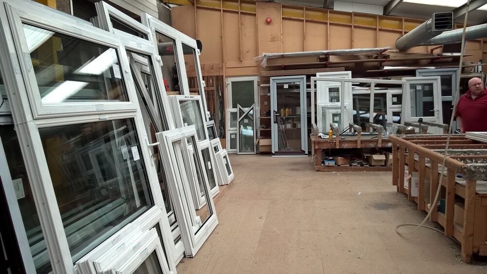 Newly manufactured windows lined up against the wall