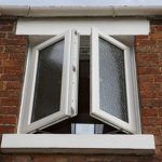 french casement windows on a bathroom wall with frosted glass