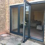sliding folding doors in grey aluminium
